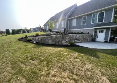 Wide lawn view of completed hardscape project in Johnston RI