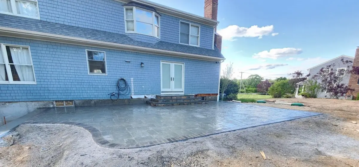 Patio base and pavers freshly installed — construction phase of Johnston RI project